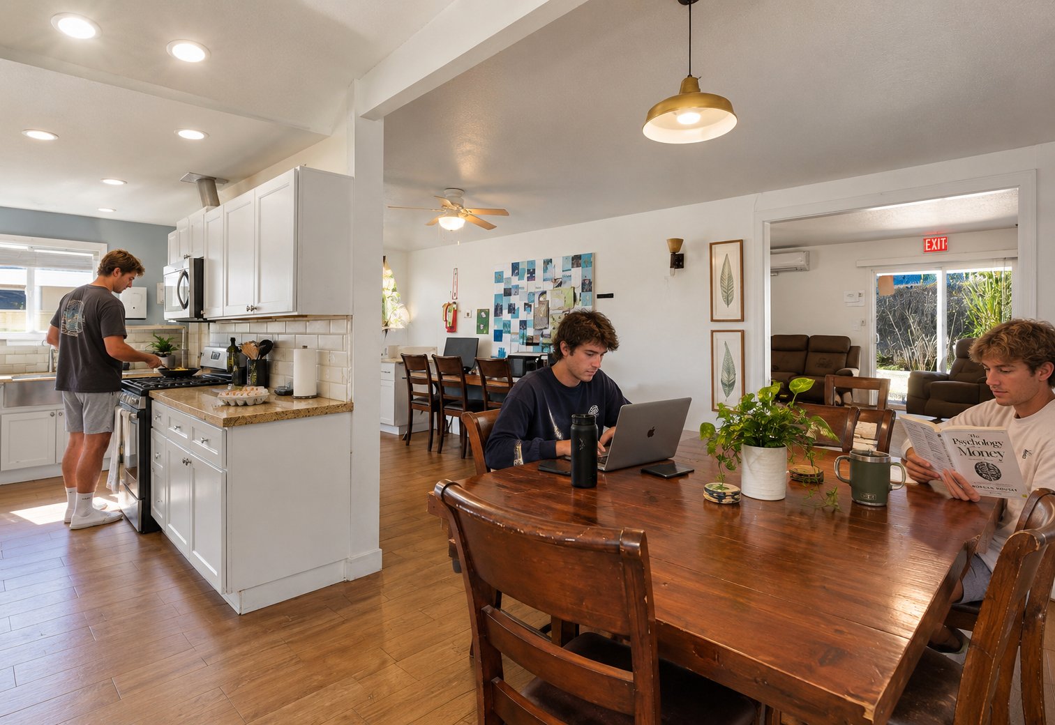 Residents cooking, working and reading in the shared kitchen and dining room