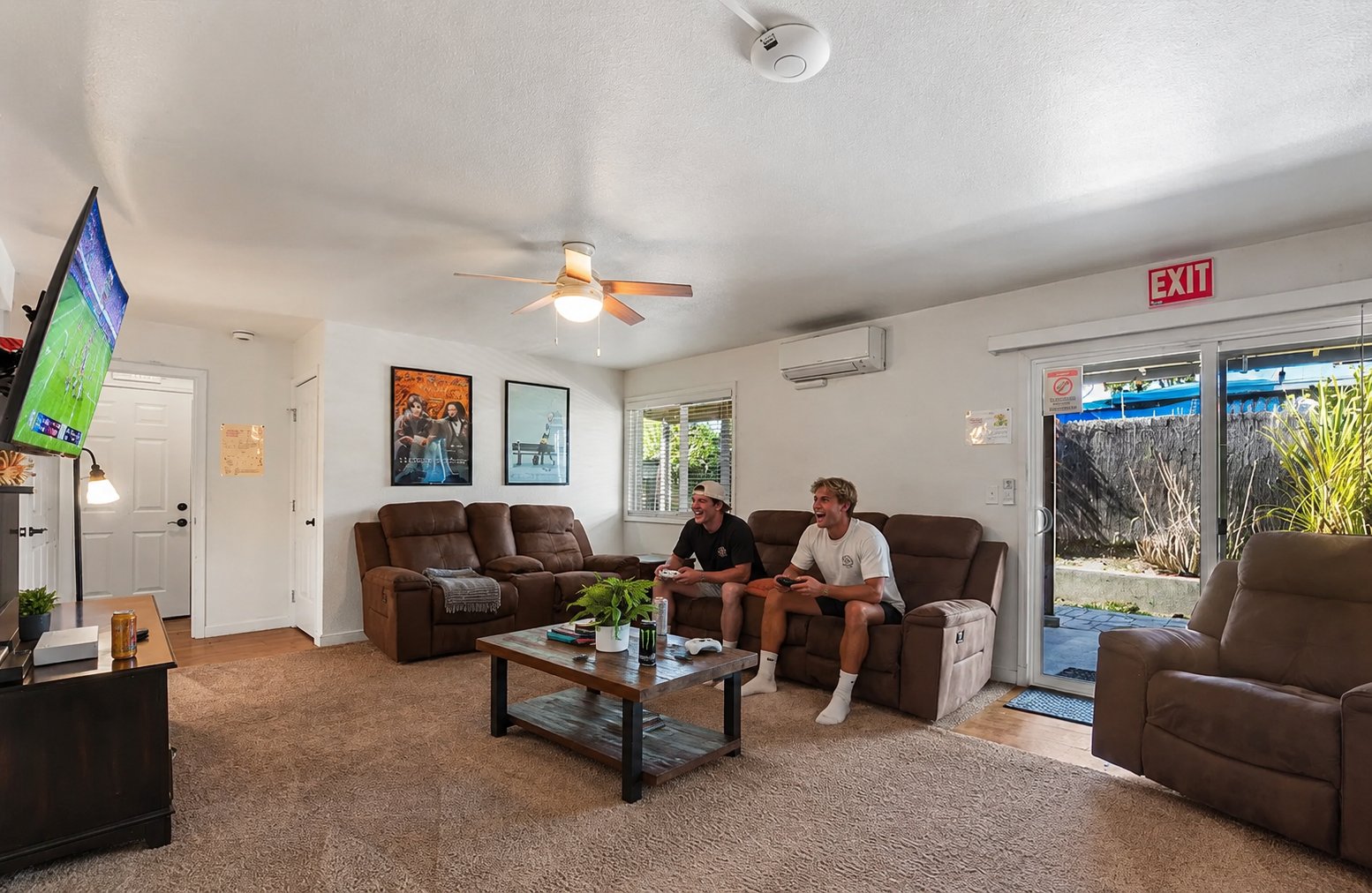 Two residents playing video games in the living room